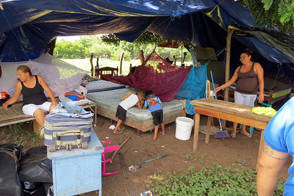 Families sleep in a make-shift shelter, following earthquakes and aftershocks.